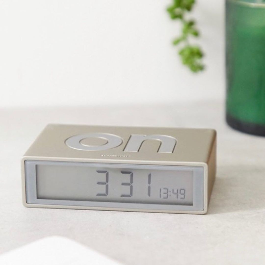 A double-sided alarm clock with the word &quot;on&quot; inscribed on top