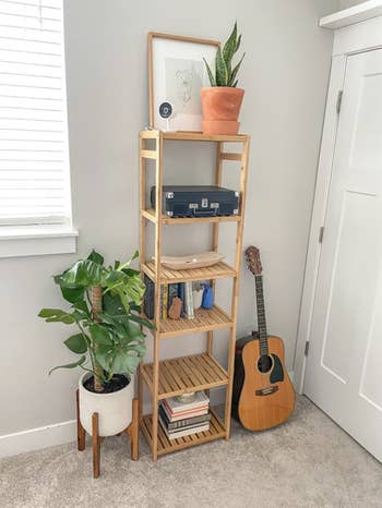 vertical shelf in a bedroom with various things stored on it