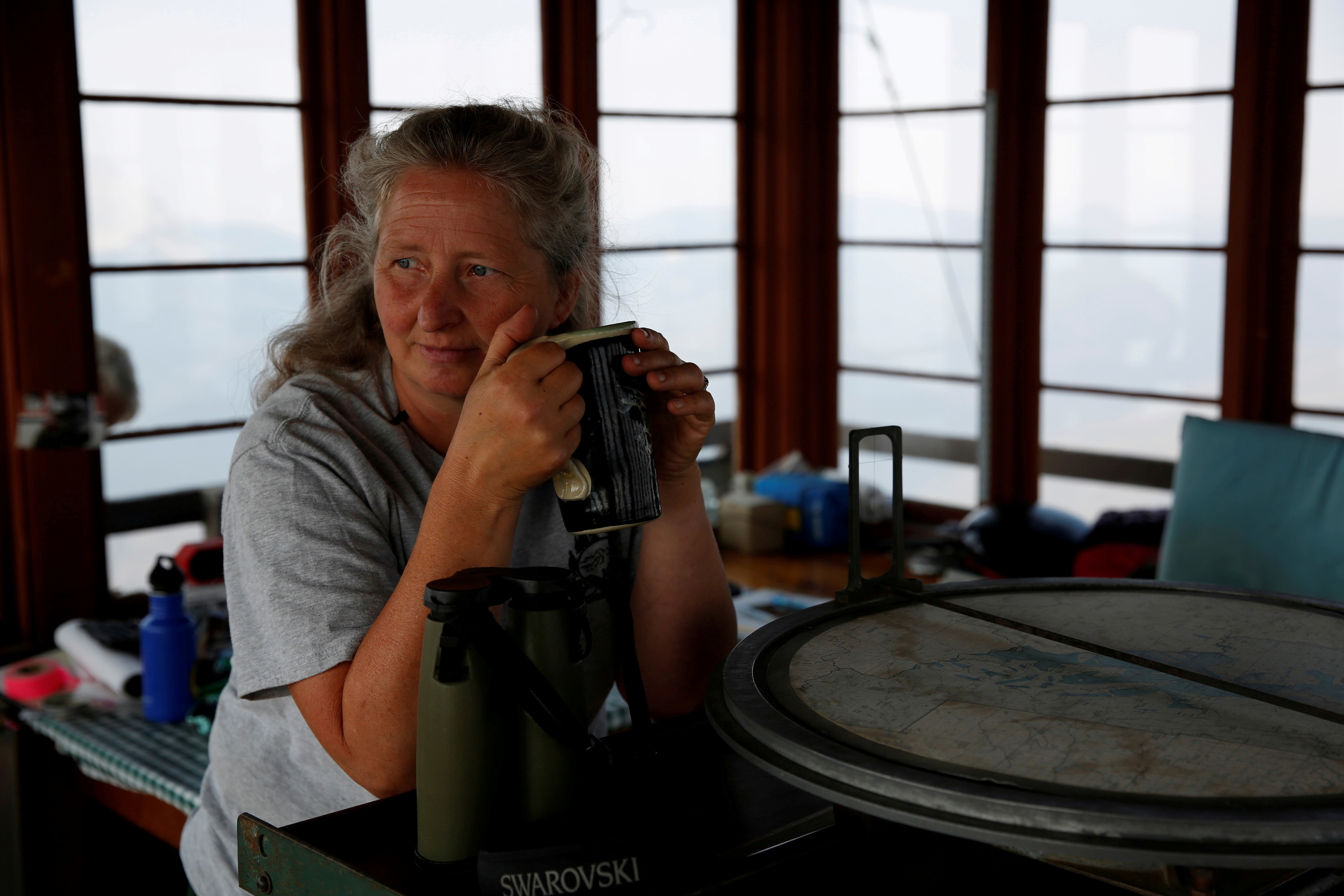 Samsara Duffey relaxes with a cup of coffee at the Patrol Mountain Fire lookout