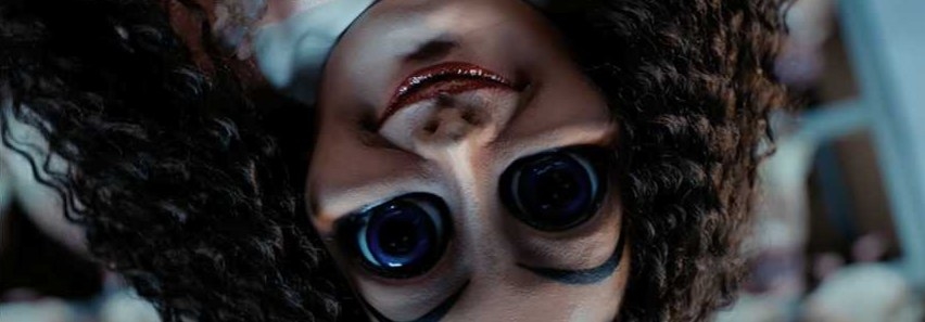 Bid-eyed creepy doll upside-down