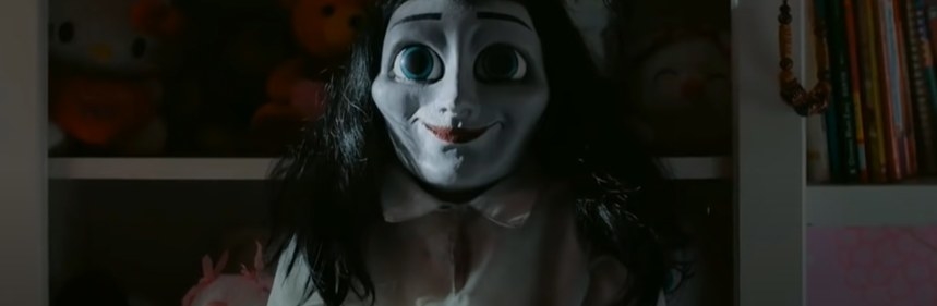 Big-eyed creepy doll smiling
