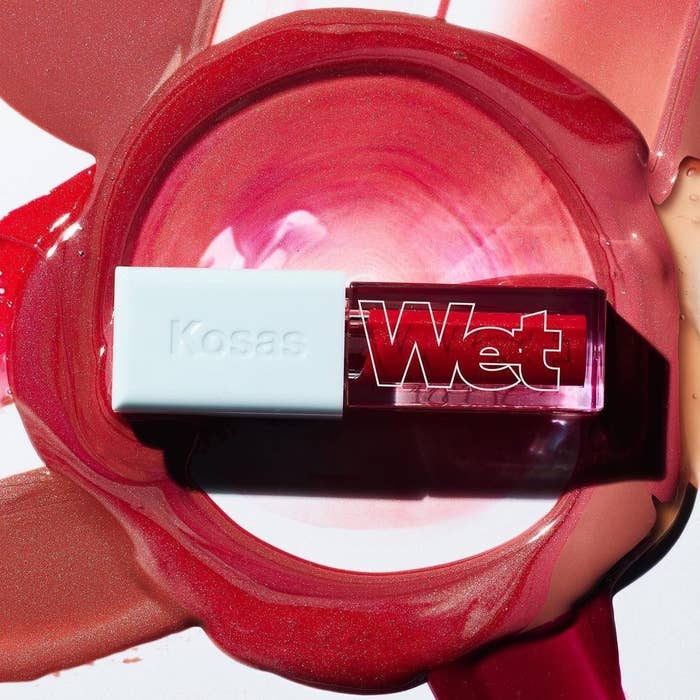 A tube of lip oil with a swatch of product around it