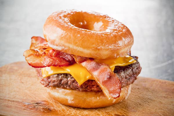 A bacon cheeseburger that has glazed donuts as buns