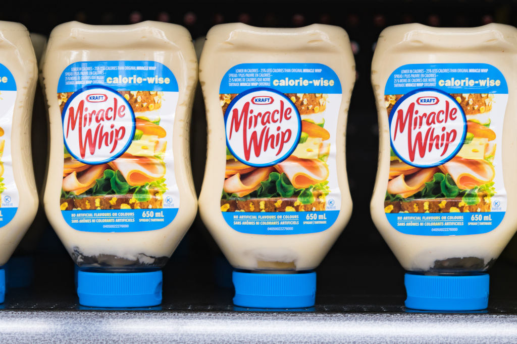 Bottles of Miracle Whip along a grocery shelf