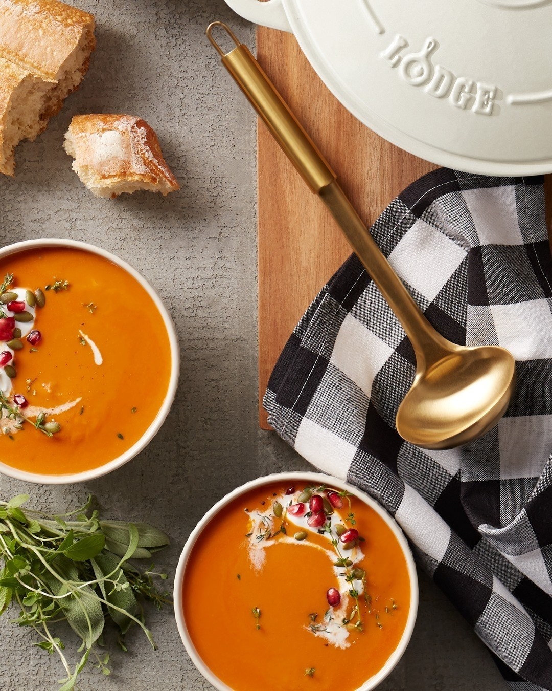 Top down image of soup bowls and ladle on table