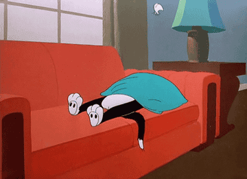 GIF of cat sleeping on couch in &quot;Looney Tunes&quot;