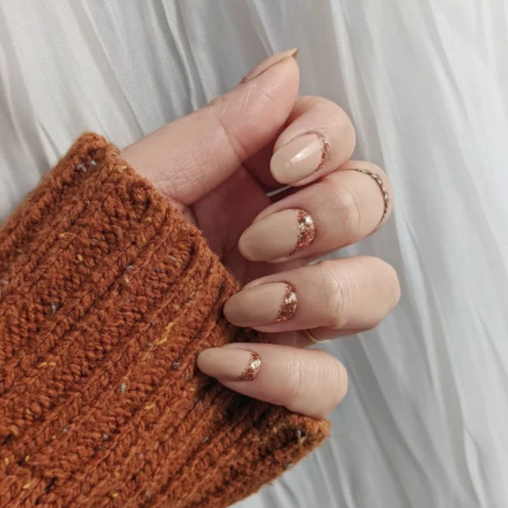 person wearing chai latte nail polish on nails