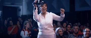 Kris Jenner dancing and holding a camcorder