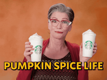 A woman holds two pumpkin spice lattes in her hands while dancing before text that says &quot;Pumpkin Spice Life&quot;