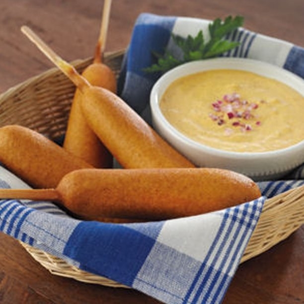 meat-free corn dogs in a basket next to dip