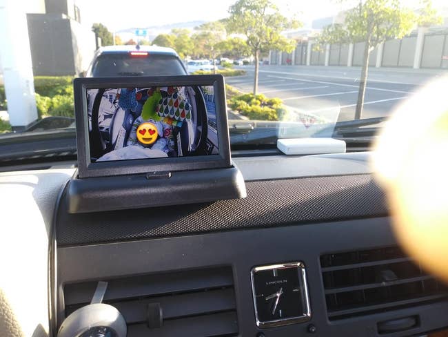 Reviewer's photo of their child on the screen on their dash board