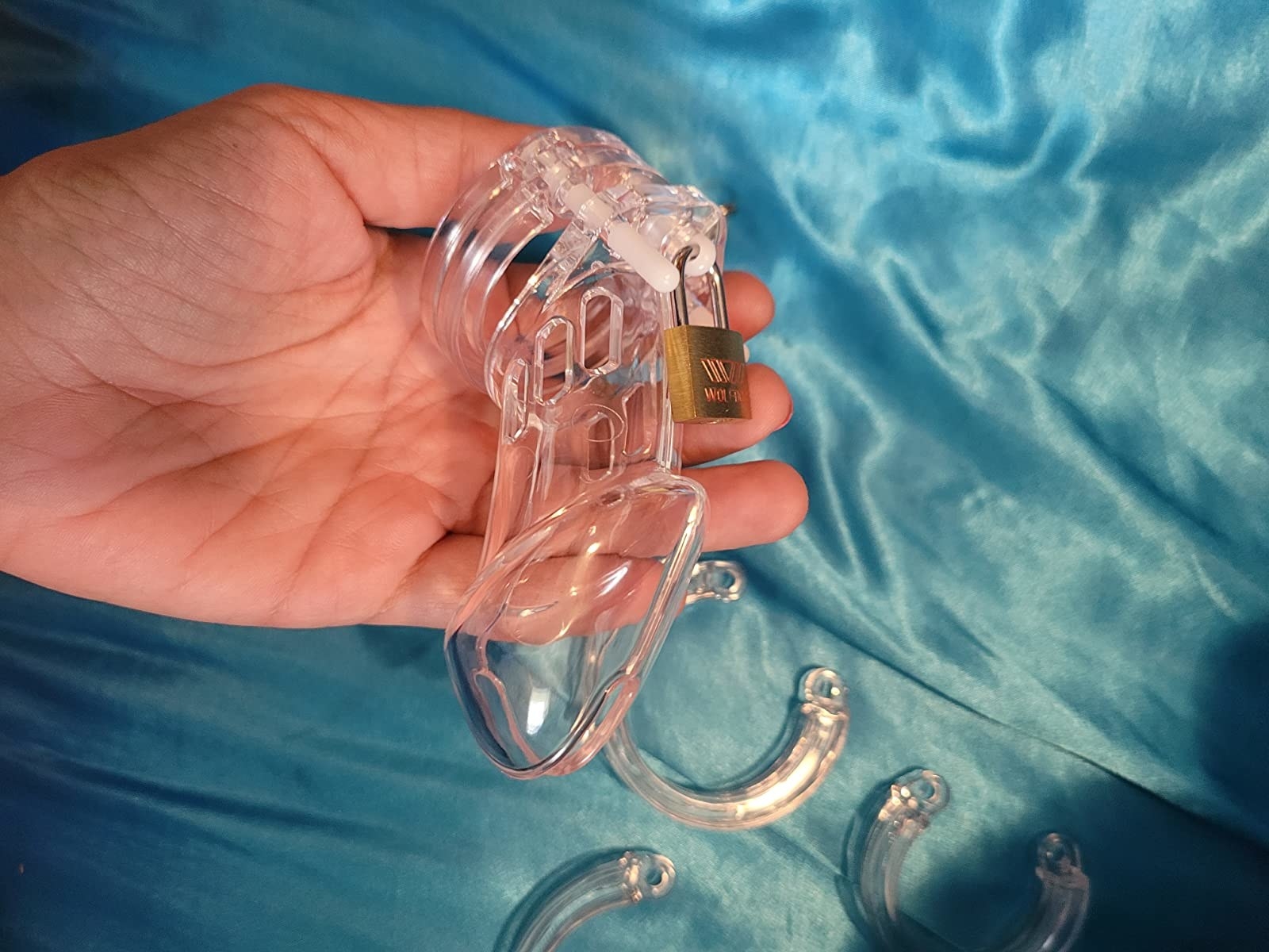 Reviewer holding transparent chastity cage