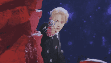 Shinee&#x27;s Key holds a ray gun in his outer space themed music video for Bad Love