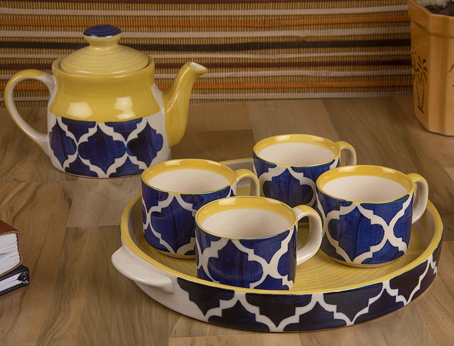 A blue and white kettle with cups on a tray
