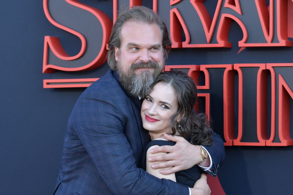 David Harbour hugging his co-star Winona Ryder