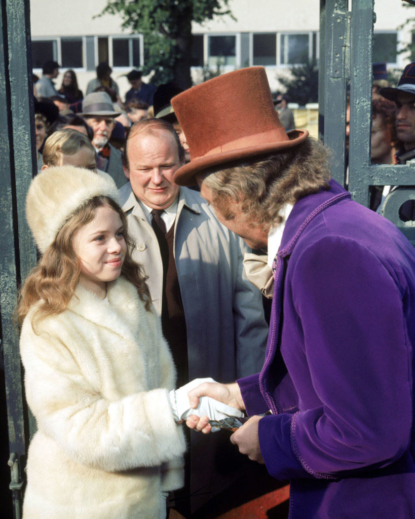 (L to R) Gene Wilder as Willy Wonka shaking hands with Julie Dawn Cole as Veruca Salt as Roy Kinnear as Mr. Salt looks on in the film &#x27;Willy Wonka &amp; the Chocolate Factory&#x27;