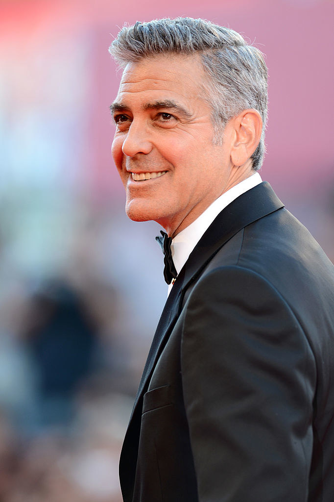 George Clooney smiles at the Opening Ceremony and &quot;Gravity&quot; premiere