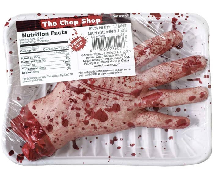 The fair hand is covered and blood splatters and is cut off at the wristĀ and is in a package titled 'The Chop Shop"