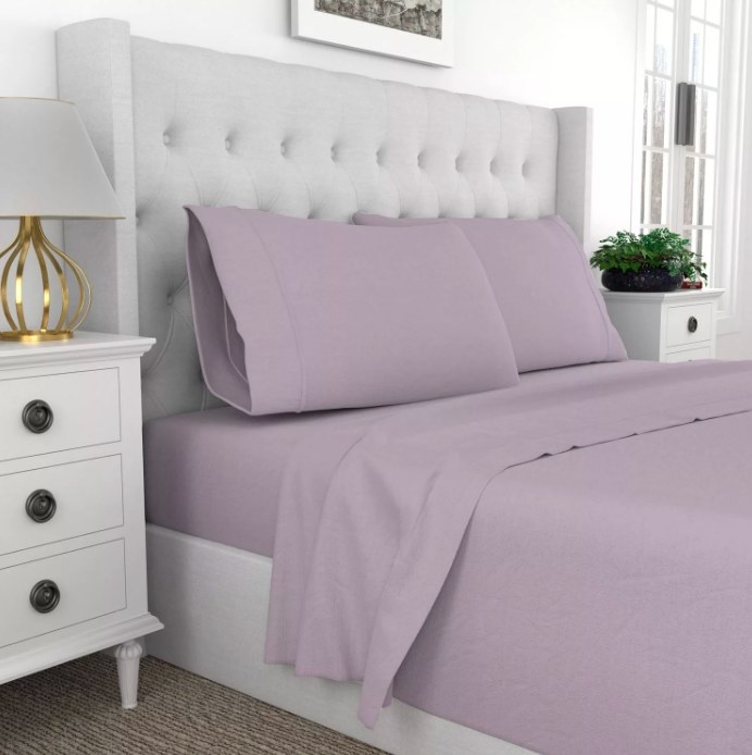 A bed made with the lavender sheets