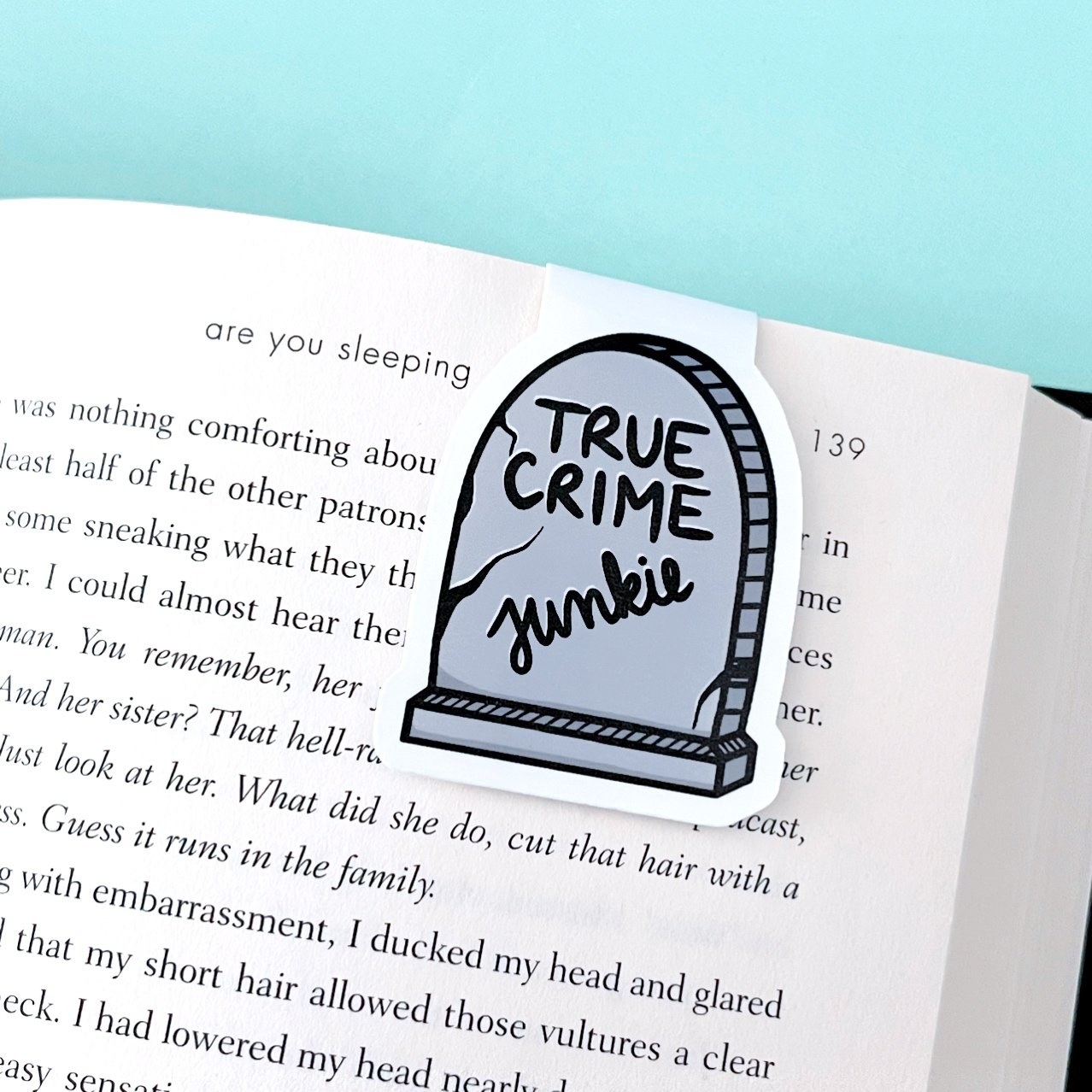 The magnetic bookmark with a tombstone and the words &quot;true crime junkie&quot; printed on it