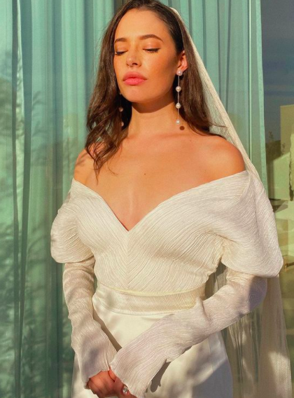 Chloe in an off-the-shoulder long-sleeved wedding gown