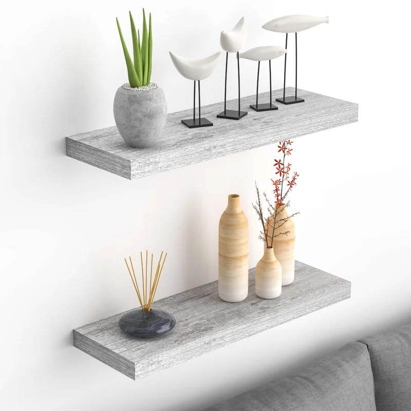 A set of gray shelves with multi-colored items on it.