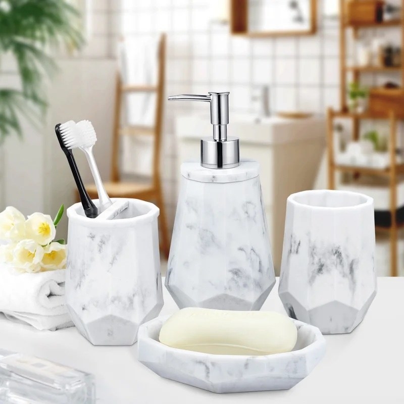 A set of white and grey marble bathroom accessories