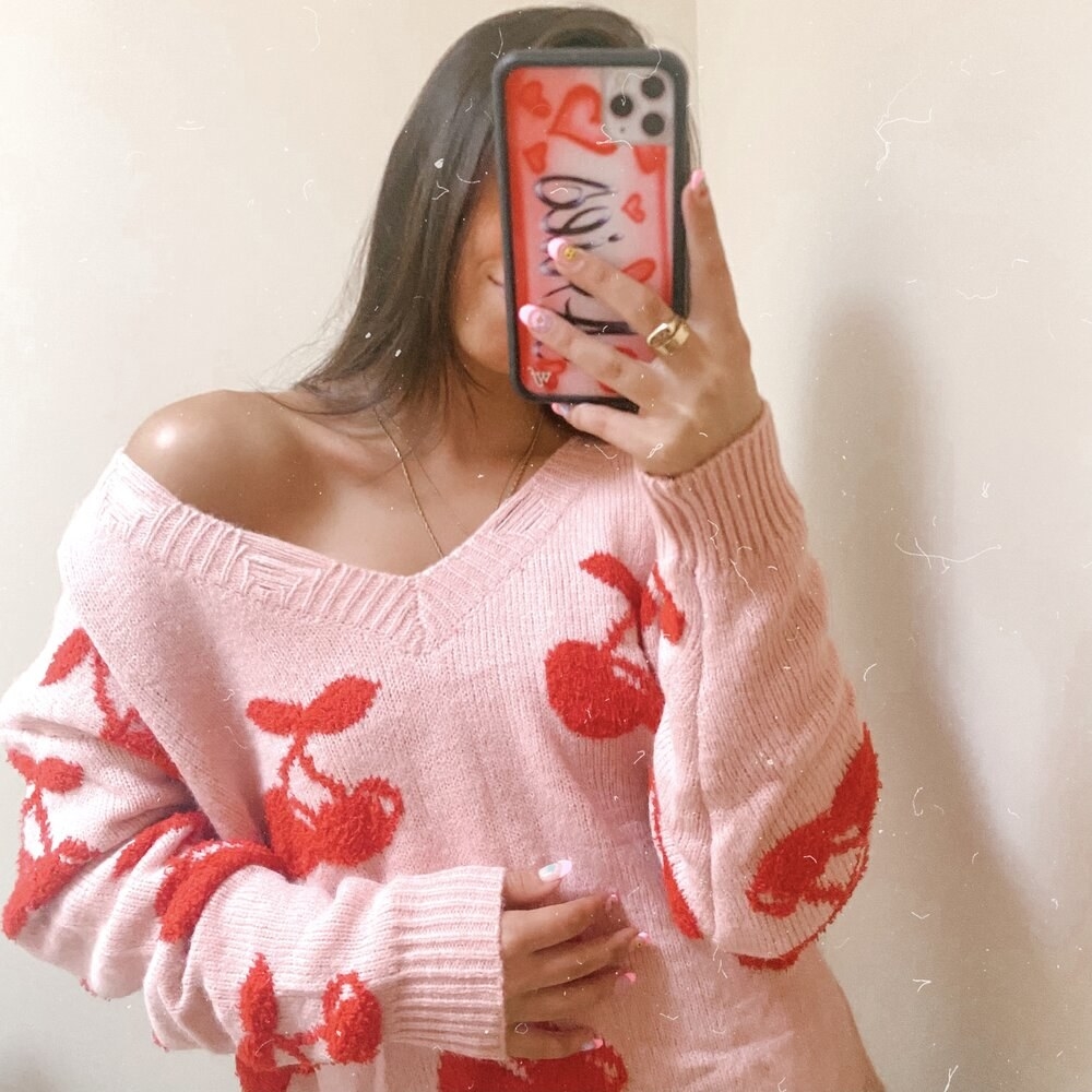 model wearing cherry sweater