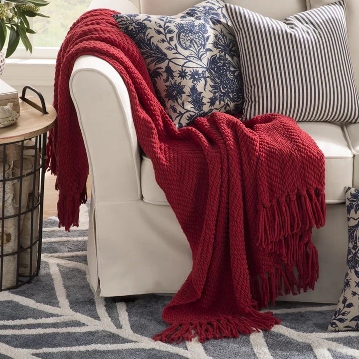 A red throw blanket on a couch