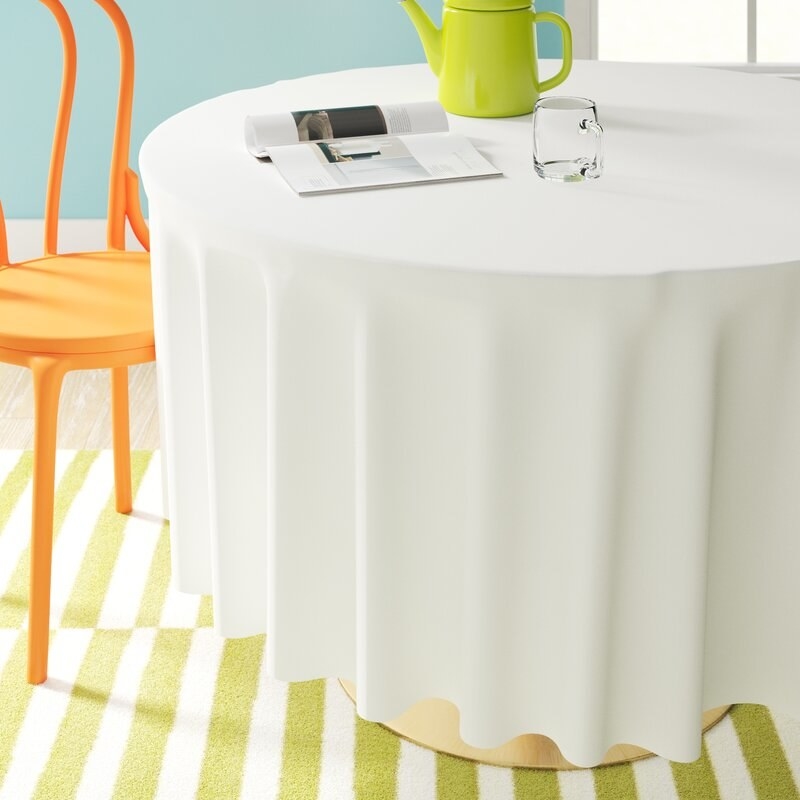 A white round tablecloth on a table