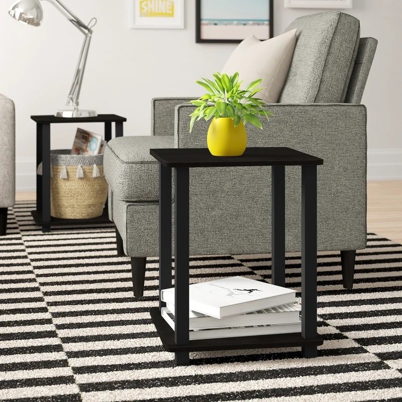 Two black end tables in a living room