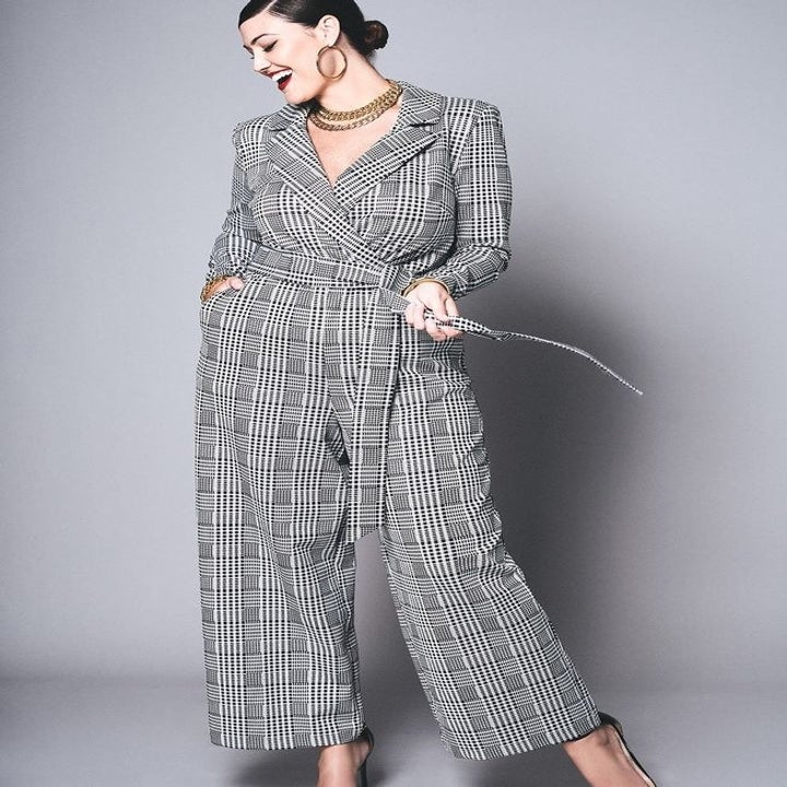 a model in a gray and white plaid wide leg jumpsuit
