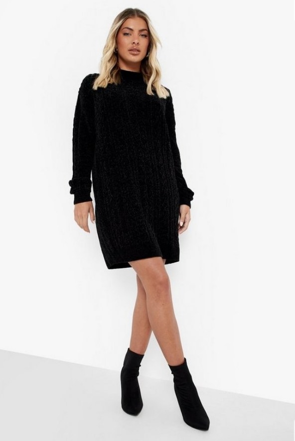 Model wearing black cable knit dress with black booties
