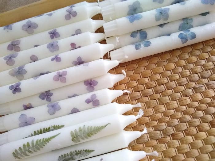 tapered white candles with florals pressed into them