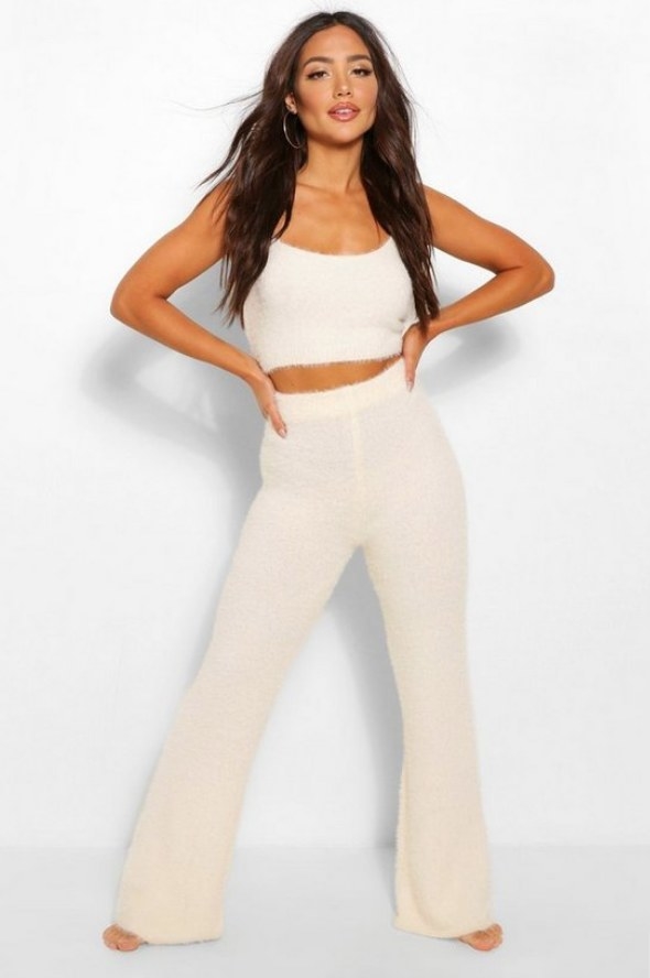 Model wearing off white fuzzy pants with matching crop top