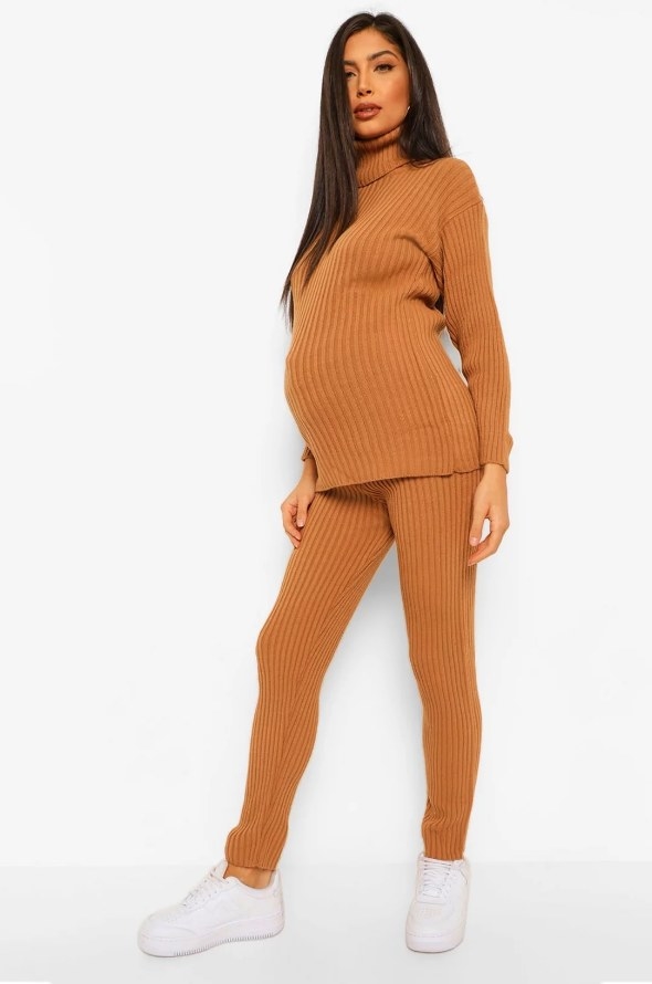 Maternity model wearing burnt orange turtle neck with matching leggings