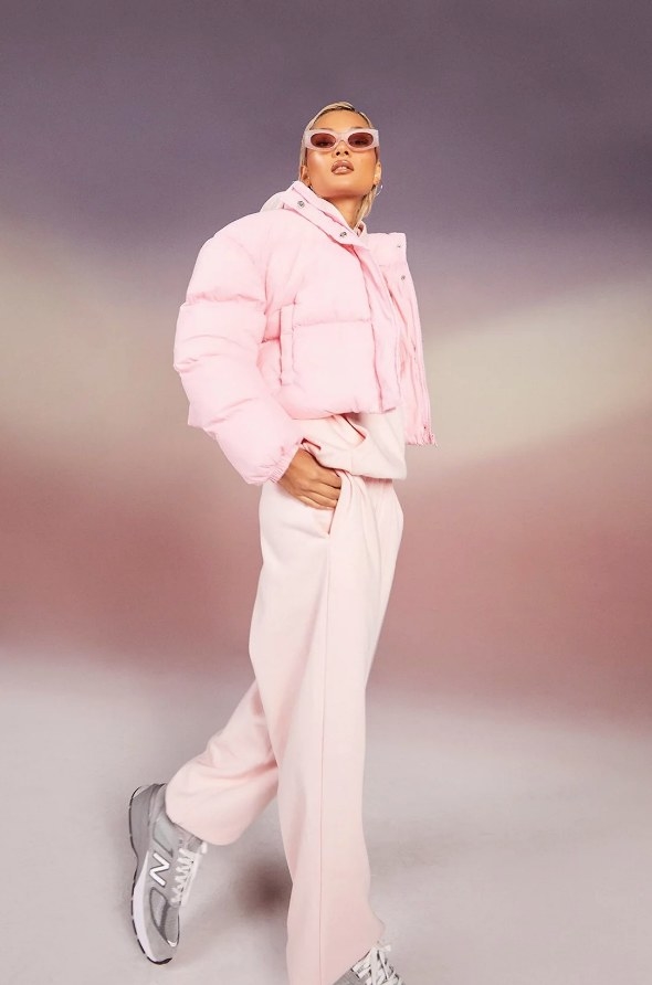 Model wearing light pink cropped puffer jacket with light pink pants