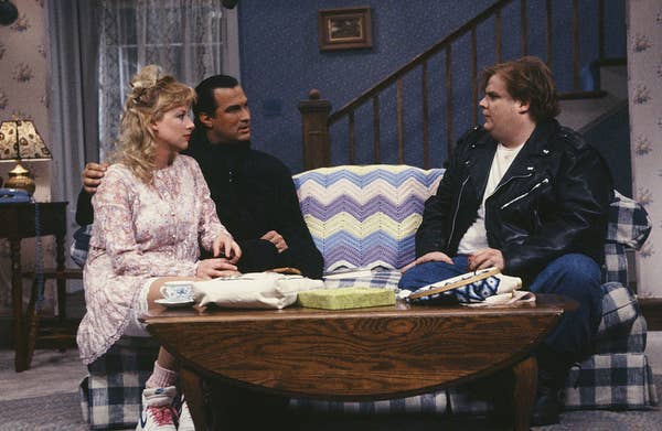 Steven Seagal seated across from Chris Farley in a living room