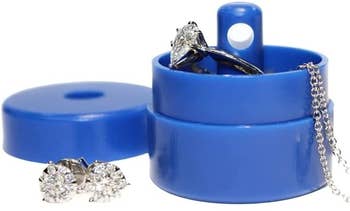 little blue round box with diamond ring inside