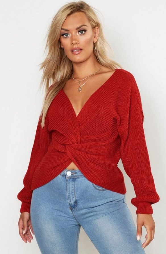 Model wearing red twist front sweater with jeans