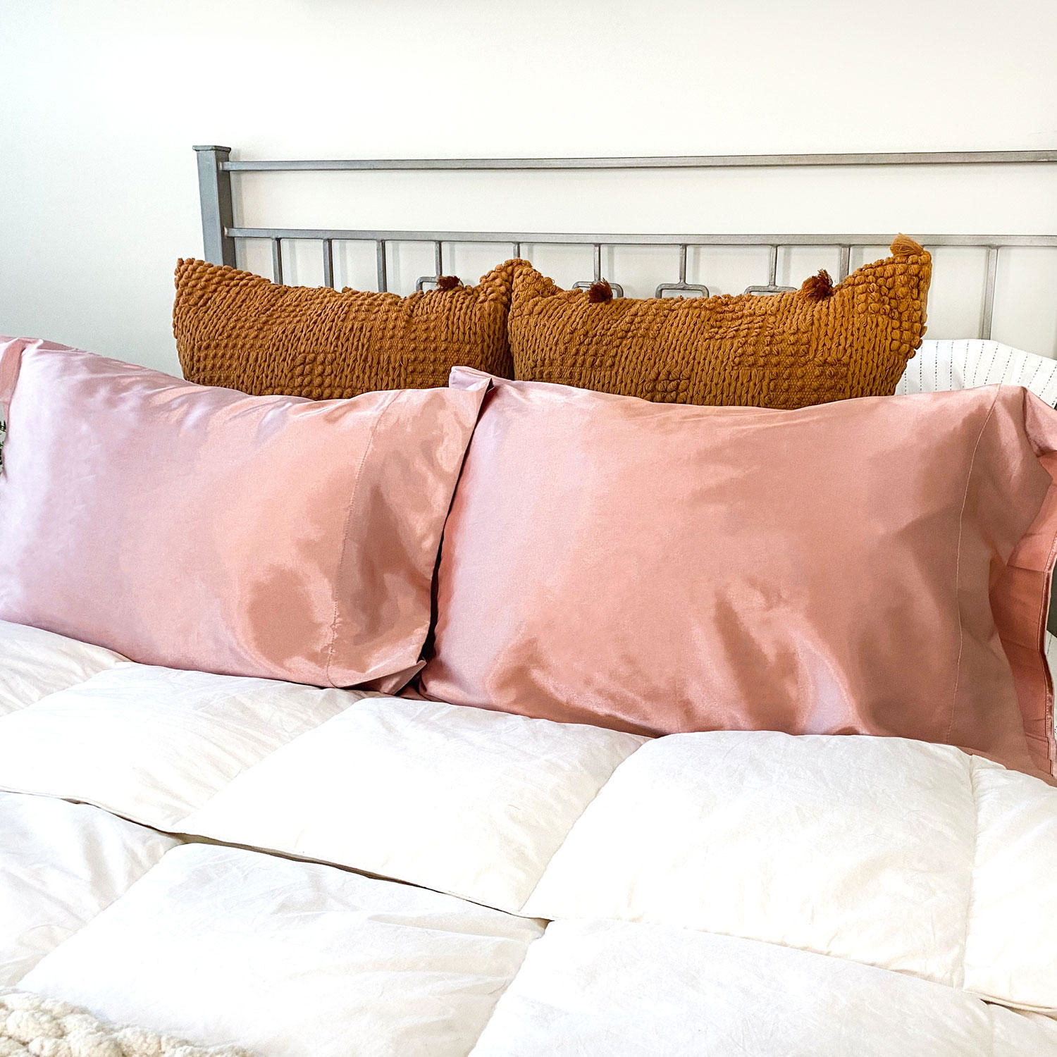 a set of two pink satin pillow cases