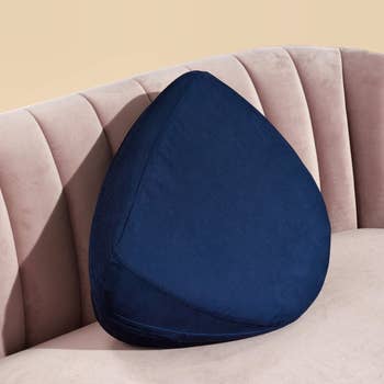 Blue wedge pillow on pink couch