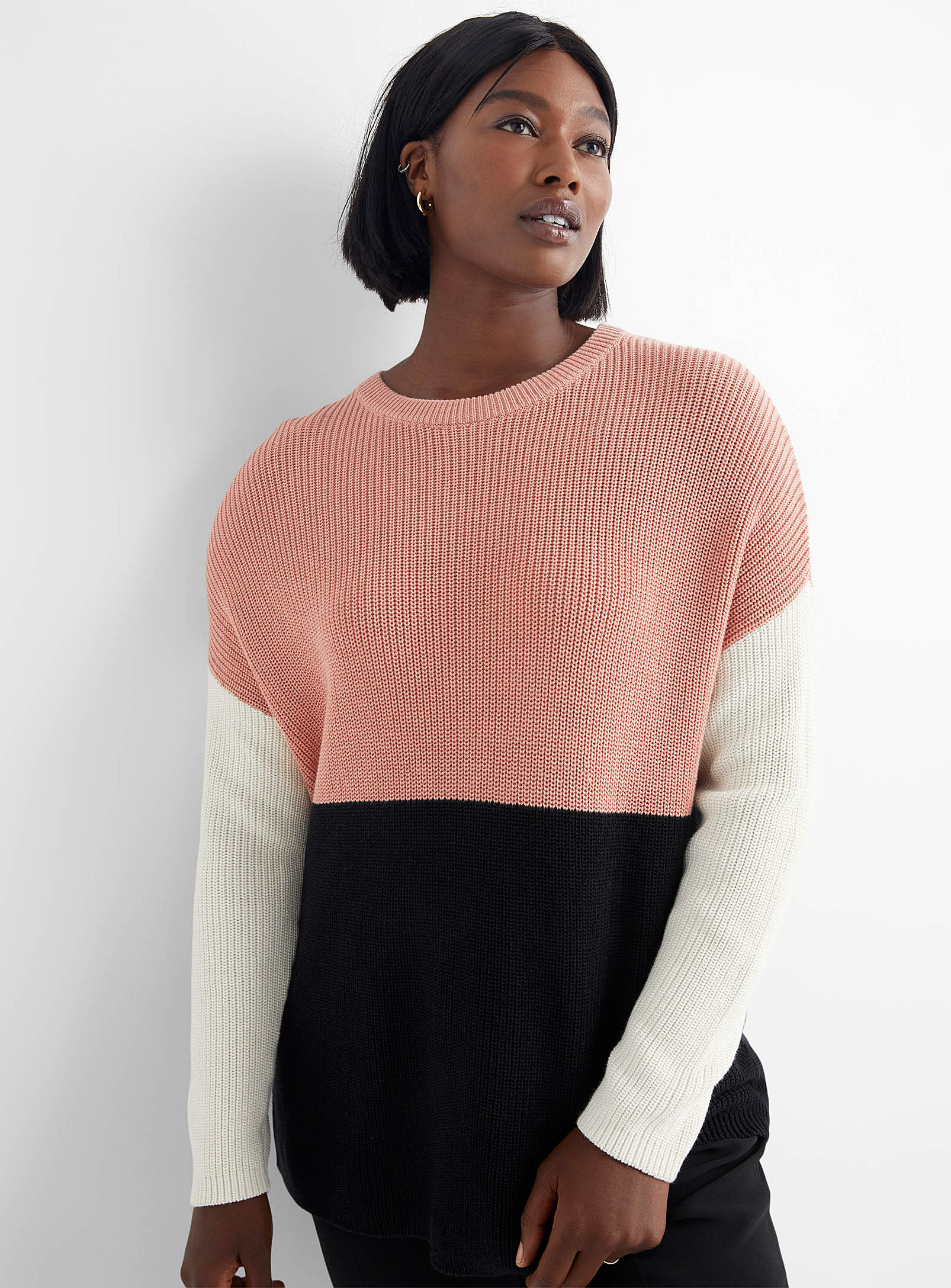 A person wear a loose knit sweater