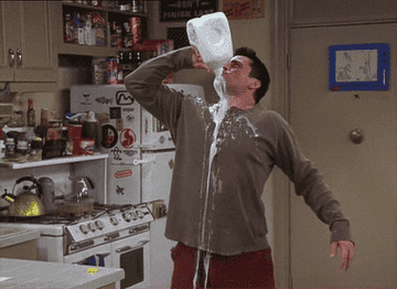 Joey from Friends chugging a gallon of milk, spills down shirt