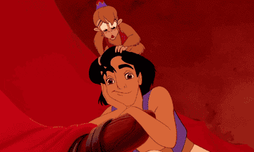 a gif of aladdin staring into space while abu waves his hand over his eyes