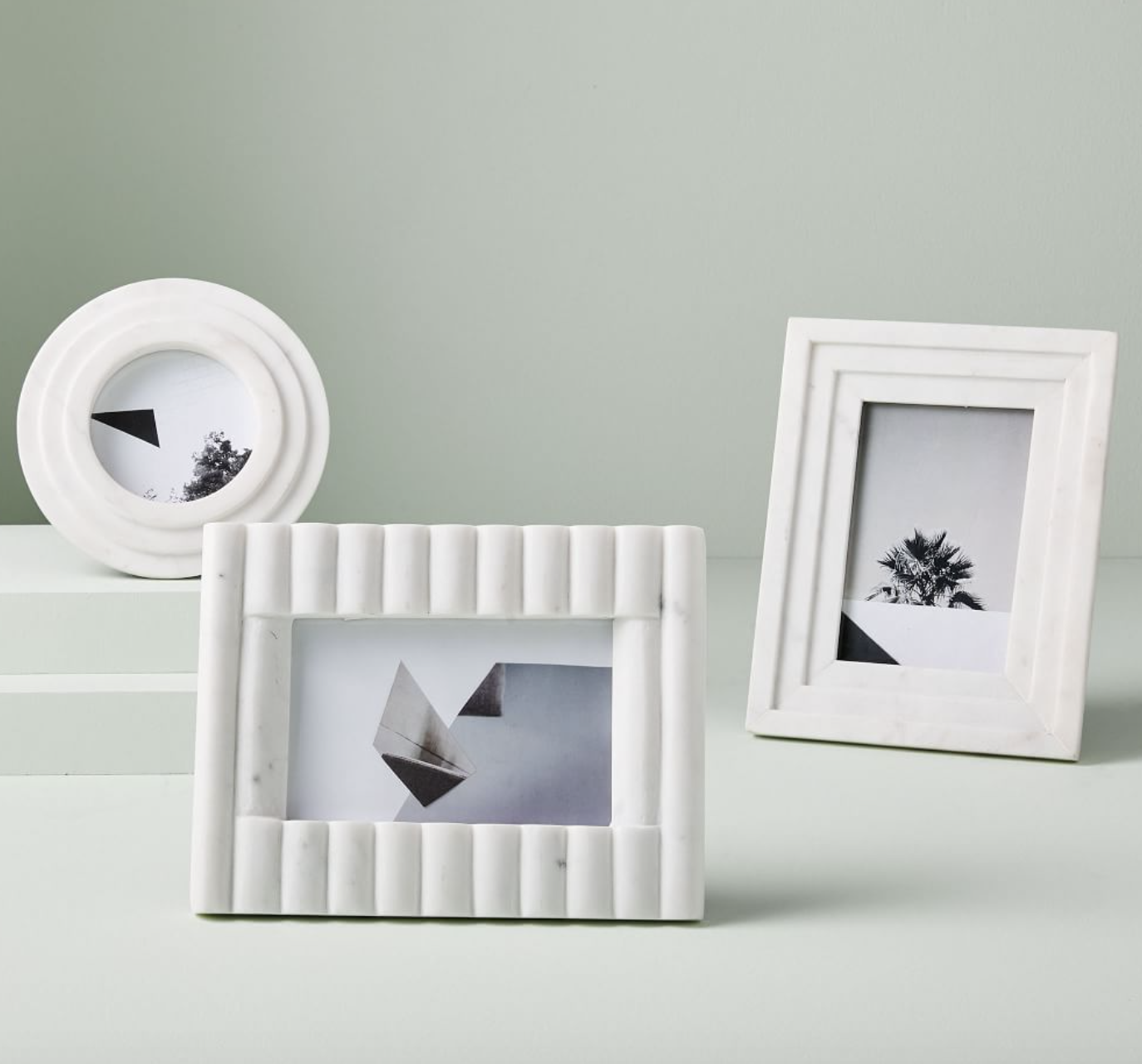 three differently shaped white marble picture frames
