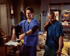 Gif of two characters dancing in their uniform on Scrubs