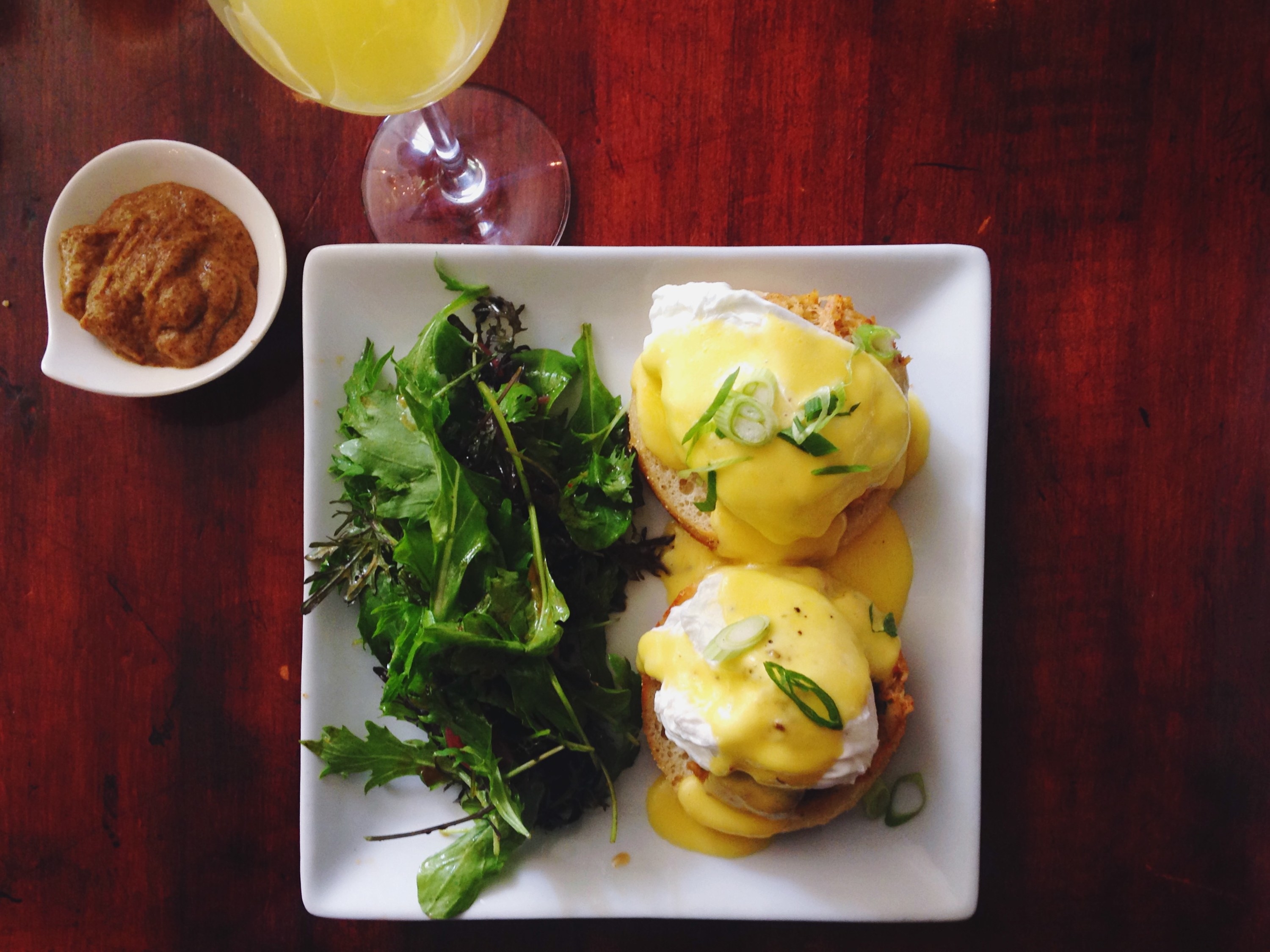 Eggs Benedict on a plate with the eggs over the muffin