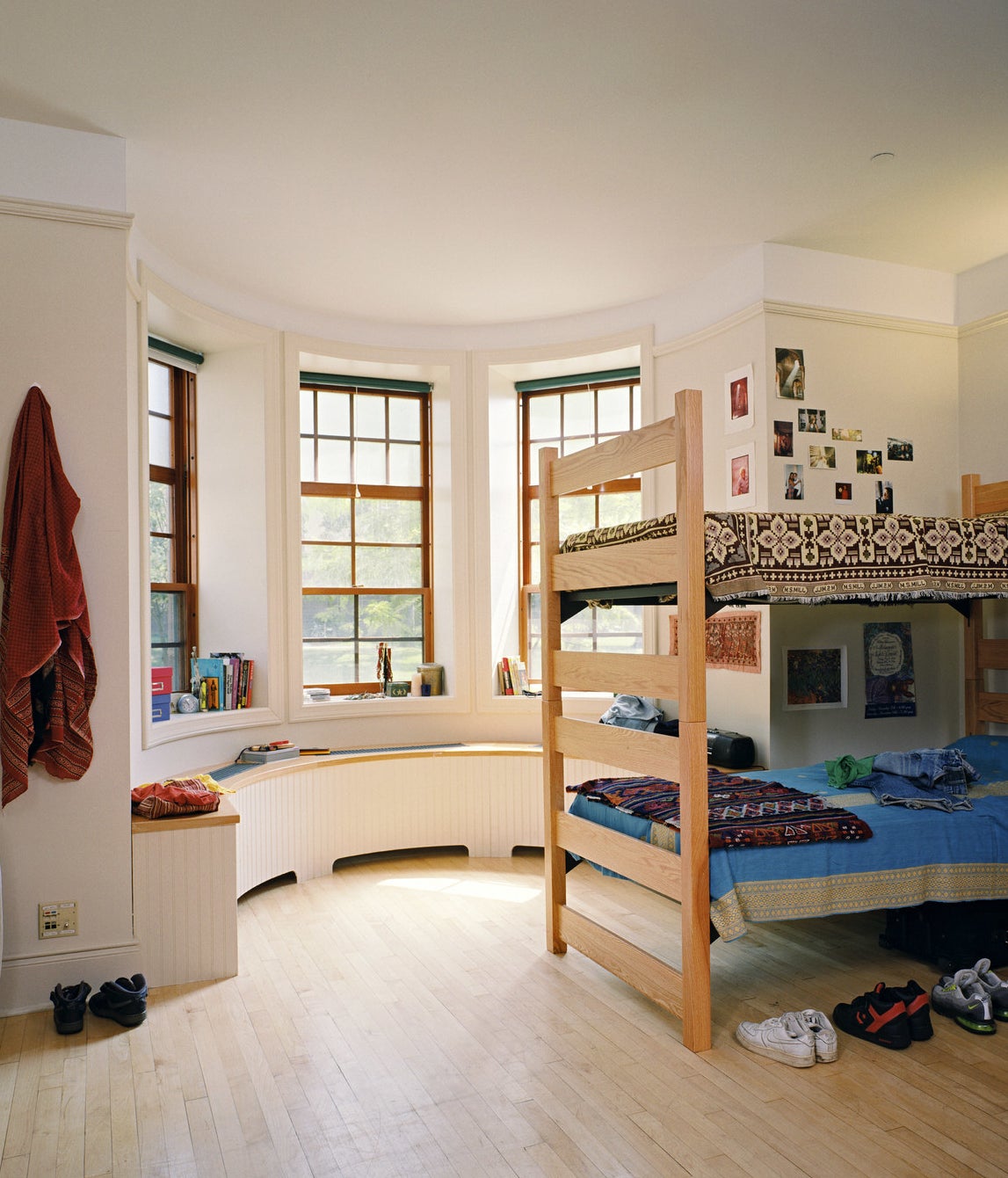 A bunk bed with clothes strewn on top