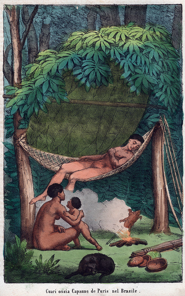 A person lounging on a hammock as another adult and a child look on